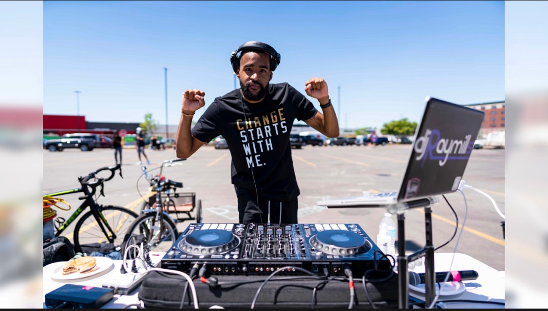 DJ Raymill performing at community event